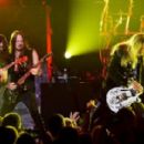 Michael Devin and guitarists Reb Beach and Joel Hoekstra of Whitesnake perform at The Joint inside the Hard Rock Hotel & Casino as the band tours in support of "The Purple Album" on June 4, 2015 in Las Vegas, Nevada.
