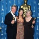Sandra Bullock stands with Stuart Craig and Stephanie McMillan at the 69th Annual Academy Awards ceremony on March 24 1997.