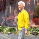 Dame Kelly Holmes – Wearing yellow bomber jacket and blond hair in London