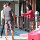 Racist, former NBA team owner Donald Sterling's ex-girlfriend V. Stiviano has a laugh when she takes a picture of a random guys t-shirt while out for lunch in Sherman Oaks, California on August 7, 2014