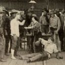 Still from the American film Rowdy Ann (1919) with Al Haynes (white shirt), Fay Tincher, and Harry Depp (on ground)