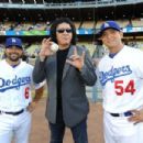 Musician Gene Simmons attends the Dodgers v Mets game to throw out the first pitch of the game at Dodger Stadium with players Aaron Miles and Javy Guerra.on July 5, 2011 in Los Angeles, California.