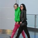 Ronnie Wood, 75, looks youthful in a vibrant green hoodie and pink trousers as he touches down in NYC with glamorous wife Sally, 45