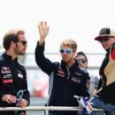 (L-R) Jean-Eric Vergne of France and Scuderia Toro Rosso, Sebastian Vettel of Germany and Infiniti Red Bull Racing and Kimi Raikkonen of Finland and Lotus attend the drivers parade before the British Formula One Grand Prix at Silverstone Circuit on June 3