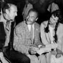 Instructions for a scene in "Springfield Rifle" are given by Andre Toth, center, to Gary Cooper and Phyllis Thaxter, who star in the Western adventure