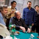 Director Curtis Hanson, Chau Giang, Jason Lester and John Juanda observe Doyle Brunson in a backstage side game between takes on the set of Warner Bros. Pictures’ and Village Roadshow Pictures’ “Lucky You.” The film stars Eric Bana