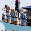 Queen's Roger Taylor uses a pole and shoots an AIRGUN at jellyfish whilst on a boat ride with his wife and children during sun-soaked holiday in Spain, 31 May 2019