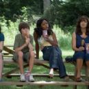 Tabby (Ashley Duggan Smith), Little Pete (Christopher Newhouse), Imogene (Jill Marie Jones), and Anora (Laura Harring) eat corn dogs in the scene of Drool.