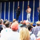 Infinti Red Bull Racing reserve driver Sebastien Buemi, former F1 driver David Coulthard and Infinti Red Bull Racing Team Principal Christian Horner talk to fans at a campsite appearance following qualifying for the British Formula One Grand Prix at Silve