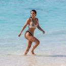 Kim Kardashian – In a black bikini in Turks and Caicos