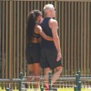 Vincent Cassel, 57, and new girlfriend Narah Baptista, 27, look affectionate as they cuddle after a sweaty workout session in Brazil
