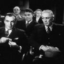 Eddie Hall who sits quietly behind Richard Lane in a scene in Youth Will be Served (1944)