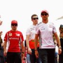 (L-R) Fernando Alonso of Spain and Ferrari, Paul di Resta of Great Britain and Force India and Jenson Button of Great Britain and McLaren attend the drivers parade before the Bahrain Formula One Grand Prix at the Bahrain International Circuit on April 22,