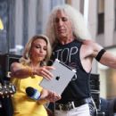 Dee Snider of Twisted Sister on stage with host Elisabeth Hasselbeck during 'FOX & Friends' All American Concert Series outside of FOX Studios on July 25, 2014 in New York City