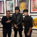 Gene Simmons poses in front of his acrylic on canvas work "The Birth" on display at the debut of Gene Simmons ArtWorks at Animazing Gallery at The Venetian Las Vegas on October 21, 2021 in Las Vegas, Nevada