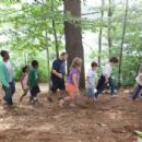 Lenny (Adam Sandler) walks through the woods with his daughter Becky (Alexys Nicole Sanger), sons Greg (Jake Goldberg) and Keithie (Cameron Boyce), Donna Lamonsoff (Ada-Nicole Sanger), Bean Lamonsoff (Frank Gingerich), Eric Lamonsoff (Kevin James), Andre