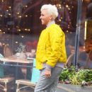 Dame Kelly Holmes – Wearing yellow bomber jacket and blond hair in London