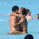 Retired footballer Ronaldo uses a selfie stick to take loved up holiday snaps in the sea with beach babe fiancé Paula Morais