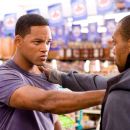A would-be thief (Aaron Toney) is confronted by Will Smith (left), who stars as Hancock, a disgruntled, conflicted, sarcastic, and misunderstood superhero whose well-intentioned heroics might get the job done and save countless lives, but always seem to l