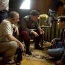 Director/Producer BRYAN SINGER discusses a scene with TOM CRUISE (center) and the director of photography NEWTON THOMAS SIGEL. ASC (left) on the set of the suspense thriller VALKYRIE. VALKYRIE opens in theatres nationwide on December 25, 2008. © 2008 Unit