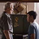 (L-r) Walt Kowalski (CLINT EASTWOOD) and Thao (BEE VANG) in Warner Bros. Pictures' and Village Roadshow Pictures' drama 'Gran Torino,' distributed by Warner Bros. Pictures. Photo by Anthony Michael Rivetti