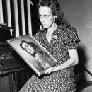 Mrs. Florence Spangler, listening to radio as she holds photo of her missing daughter, Jean Elizabeth Spangler.
