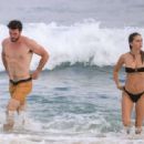 Gabriella Brooks in Black Bikini and Liam Hemsworth on the beach in Byron Bay - 454 x 316