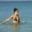 Amy Willerton – In a green bikini on the beach in Dubai - 454 x 321