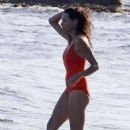 Minnie Driver in Orange Swimsuit on the beach in Malibu