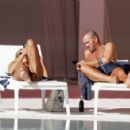 Arabella Chi – Seen by the pool with a mystery male friend in Ibiza - 454 x 294