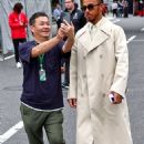 Lewis Hamilton looks trendy in a cream trench coat ahead of Japanese F1 Grand Prix - after vowing to 'come back stronger' after Singapore defeat