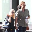 A smitten looking Dakota Fanning and her boyfriend Jamie Strachan go hand in hand for a stroll around New York City - 336 x 594