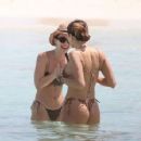 Aurora Ramazzotti – In a black bikini on holiday on the beach in Formentera - 454 x 353