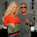 Musician Vince Neil (L) and wife Lia Gherardini pose in the Official Silver Spoon Gifting Lounge held during the 2008 American Music Awards at the Nokia Theatre on November 22, 2008 in Los Angeles, California - 454 x 492