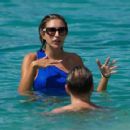 Zara McDermott – Wearing blue swimsuit on the beach in Barbados - 454 x 359