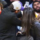 Mila Kunis and boyfriend Ashton Kutcher were all smiles as they puckered up for the Kiss Cam at a Lakers game in L.A. on Friday, Jan. 3