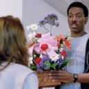 Seen here from left, Karen Mayo Chandler (back to camera) as Maitland Receptionist and Eddie Murphy as Det. Axel Foley - 454 x 256