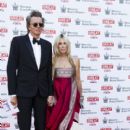 John Taylor and Gela Nash Taylor attend the Kensington Palace Summer Gala at Kensington Palace on July 9, 2015 in London, England. - 400 x 600