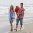 Cam Gigandet with his wife Dominique Geisendorff and their daughter Everleigh Ray on the beach in Malibu, CA (July 4)