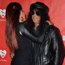 Musician Slash (R) and Perla Hudson attend the MusiCares MAP Fund Benefit Concert at Club Nokia on May 12, 2014 in Los Angeles, California - 427 x 594