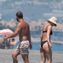 Vogue Williams – In a black bikini at the beach in Costa Del Sol - 454 x 681