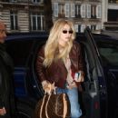 Gigi Hadid – Wearing a Holzweiler brown jacket paired with Adidas sneakers in Paris