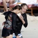 Paul McCartney, 80, dons his swimming trunks for a dip in the Caribbean sea with his wife Nancy, 63, during St Barts holiday