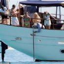 Queen's Roger Taylor uses a pole and shoots an AIRGUN at jellyfish whilst on a boat ride with his wife and children during sun-soaked holiday in Spain, 31 May 2019 - 454 x 303
