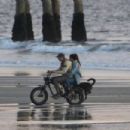 Kelly Gale – With Joel Kinnaman on the beach riding a Super73 electric bicycle in Venice - 454 x 303