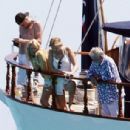 Queen's Roger Taylor uses a pole and shoots an AIRGUN at jellyfish whilst on a boat ride with his wife and children during sun-soaked holiday in Spain, 31 May 2019 - 306 x 364