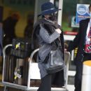 Catherine Zeta-Jones is stylish in a fedora and Gucci belt as she arrives at JFK Airport with husband Michael Douglas