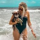 Electra Mustaine in a black swimsuit with her dog Romeo - 454 x 567