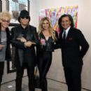 Gene Simmons poses in front of his acrylic on canvas work "The Birth" on display at the debut of Gene Simmons ArtWorks at Animazing Gallery at The Venetian Las Vegas on October 21, 2021 in Las Vegas, Nevada