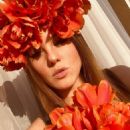 Viola Bailey (Violeta Jurgis Arturovna) wears a red flower crown - Instagram - March 6, 2020